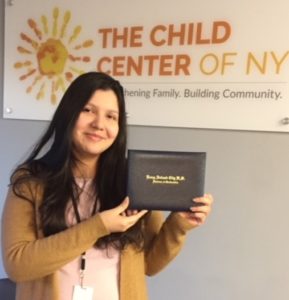 Jessica, a Child Center of NY client, with her high school diploma from Young Adult Borough Center at Flushing High School