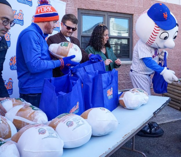 Mr. Met and others from NY Mets hand out turkeys for Thanksgiving as part of Metsgiving