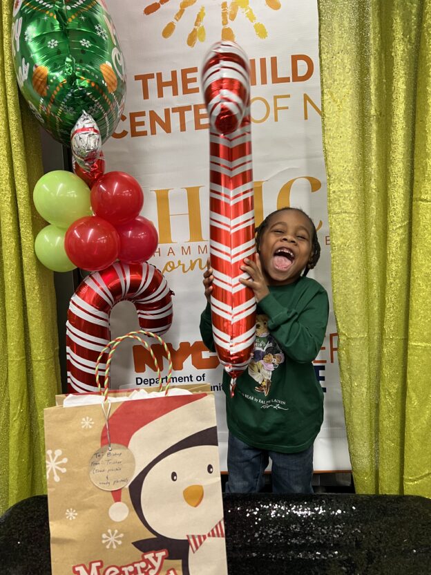 Bishop, 5, a participant in the afterschool program at Hammel Houses Cornerstone Community Center, is delighted to receive a plushy toy, courtesy of the Child Center holiday toy drive.