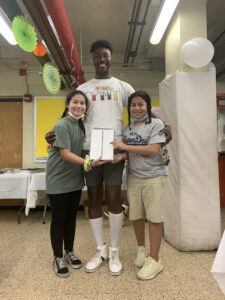 Simeon poses with two Redfern Cornerstone Community Center YMI participants upon receiving their iPads.