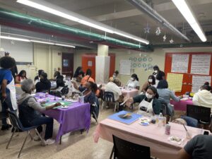 Adults gather at Redfern Cornerstone Community Center for a Sit and Paint event.