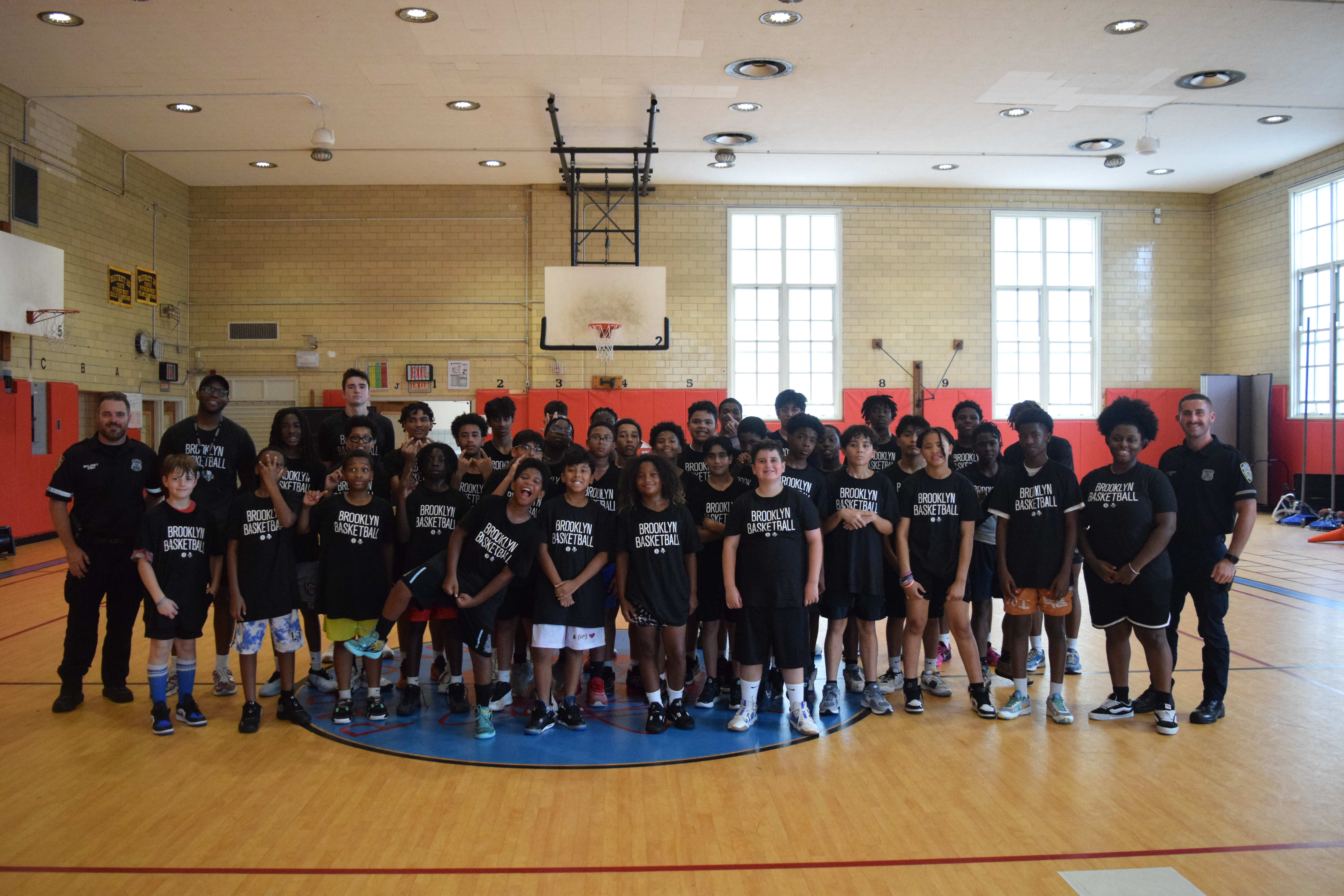 Students of our Parsons Community School program pose for a photo with Brooklyn Nets trainers and community partners.