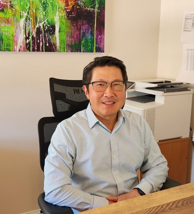 Kwan Wong at his desk in 2024