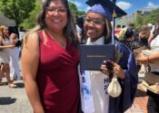 The author, Madison, poses in a cap and gown on high school graduation day with her therapist, Jennifer Trujillo-Armijo, LMSW, from her school's school-based mental health center.