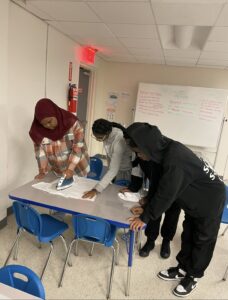 Members of the youth council working on the shirts they designed.