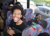 Dionte is sitting next to a fifth-grade participant. Dionte is laughing and the participant is smiling.