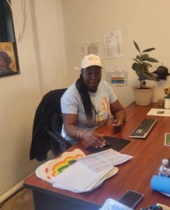 Micha sits at her desk at Oceanside Cornerstone Community Center.
