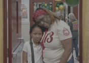 PAPP president Judeen poses standing with her third grade daughter at an afterschool event.