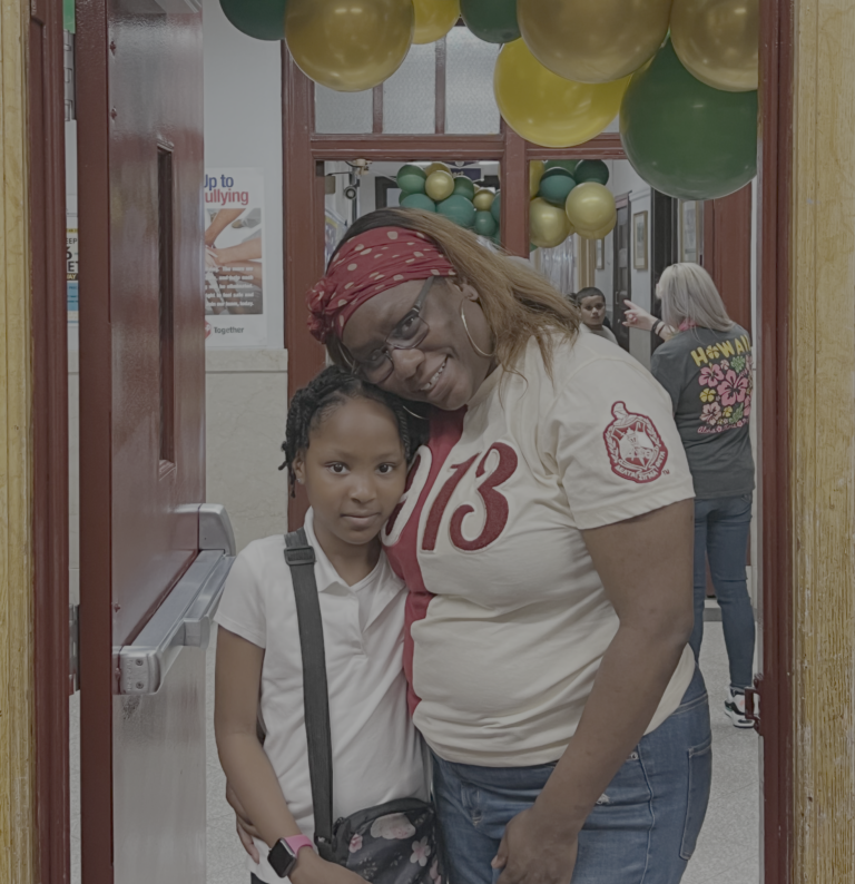 PAPP president Judeen poses standing with her third grade daughter at an afterschool event.